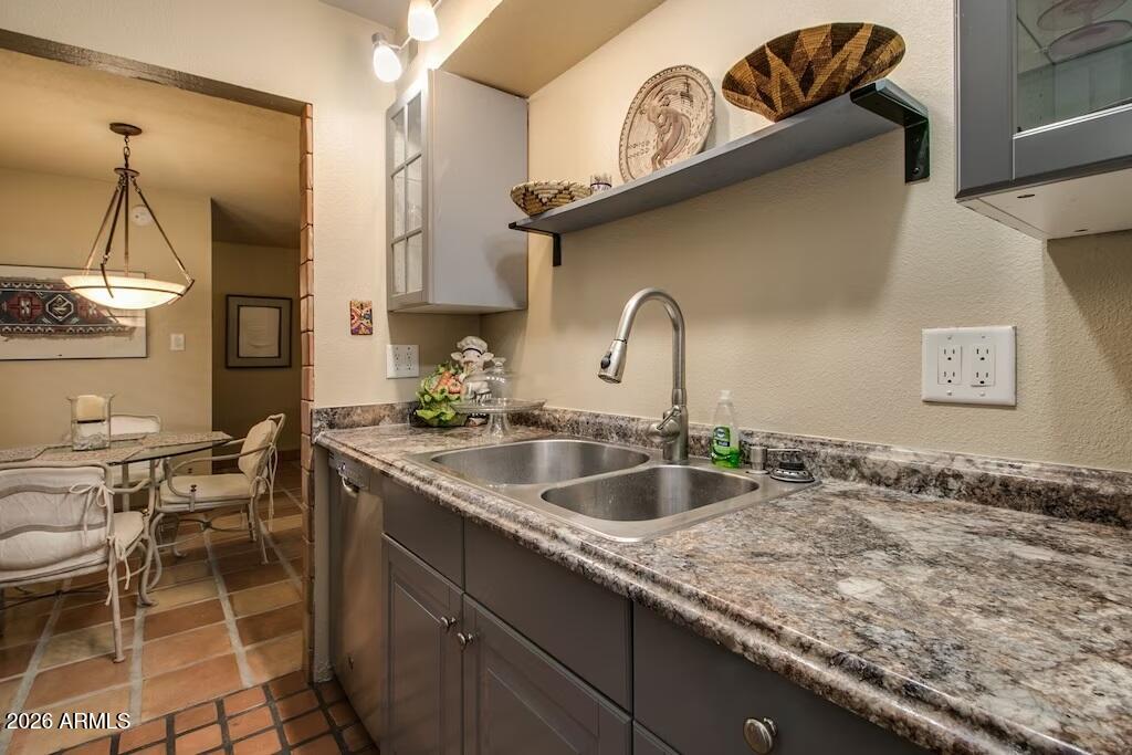 7625 East Camelback Road, Unit B117 Scottsdale, AZ 85251 - Photo 13 of 27 a kitchen with a sink a counter space and a stove