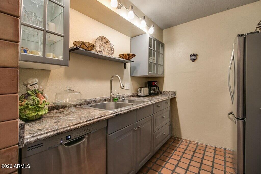 7625 East Camelback Road, Unit B117 Scottsdale, AZ 85251 - Photo 14 of 27 a kitchen with a sink and a refrigerator