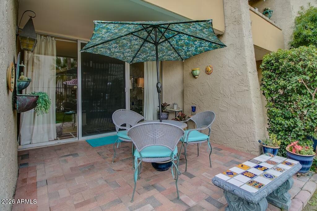 7625 East Camelback Road, Unit B117 Scottsdale, AZ 85251 - Photo 19 of 27 a patio with a table and chairs