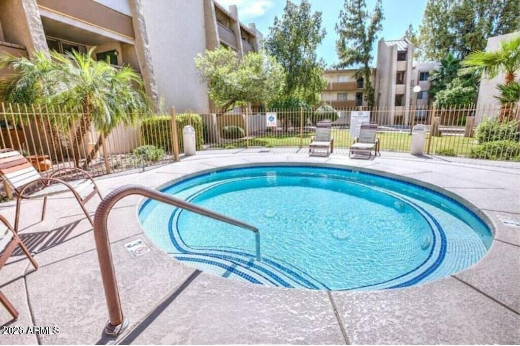 7625 East Camelback Road, Unit B117 Scottsdale, AZ 85251 - Photo 21 of 27 a swimming pool with outdoor seating and yard