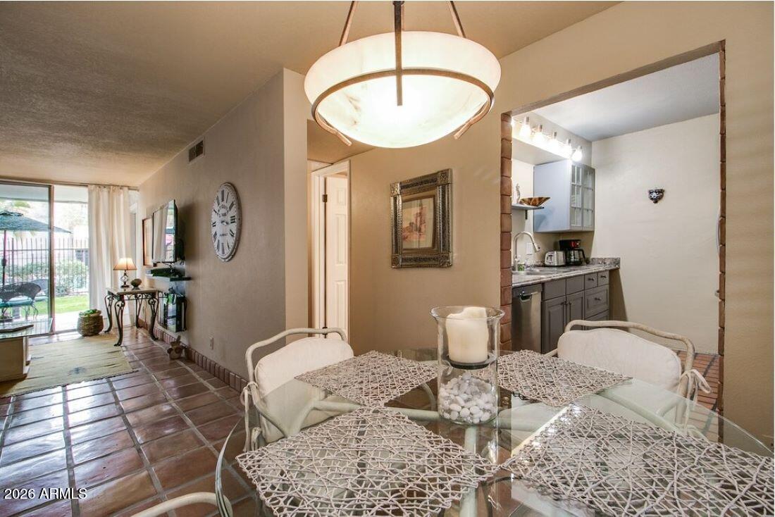 7625 East Camelback Road, Unit B117 Scottsdale, AZ 85251 - Photo 8 of 27 a bedroom with a bed a large mirror and furniture