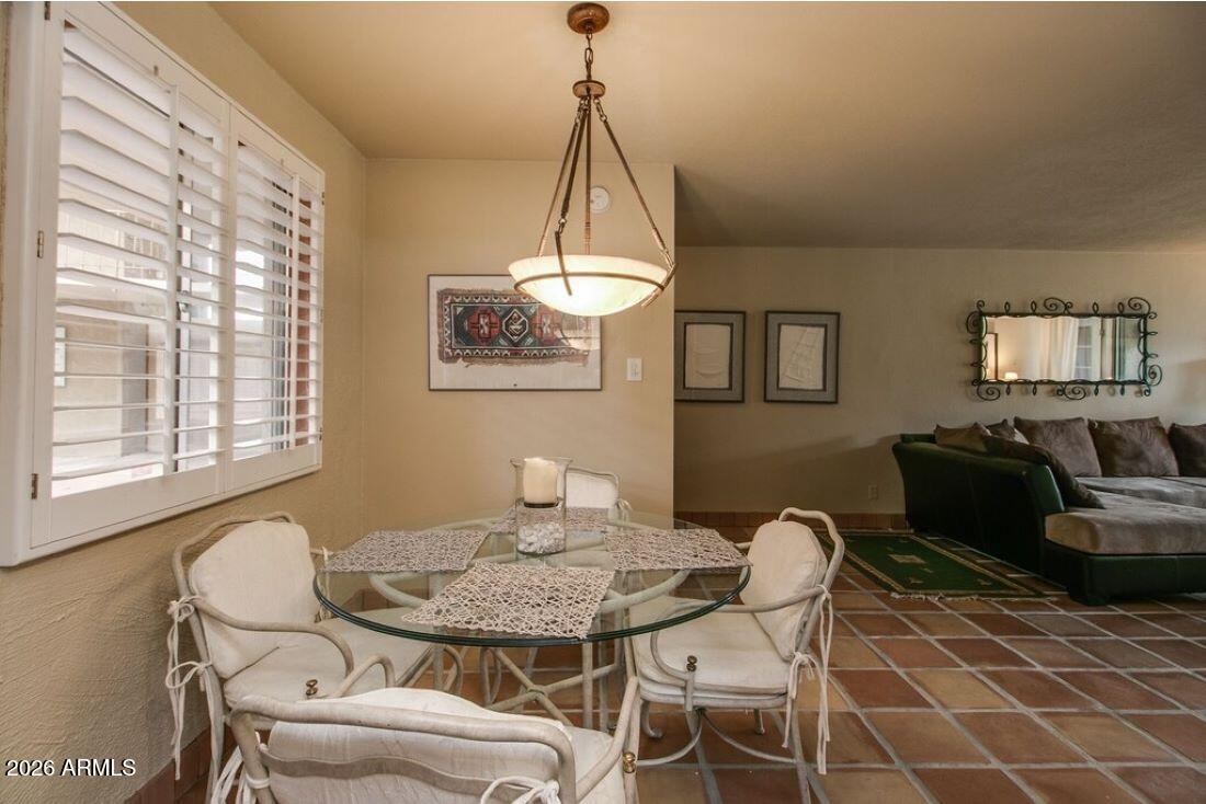 7625 East Camelback Road, Unit B117 Scottsdale, AZ 85251 - Photo 9 of 27 a dining room with furniture and window