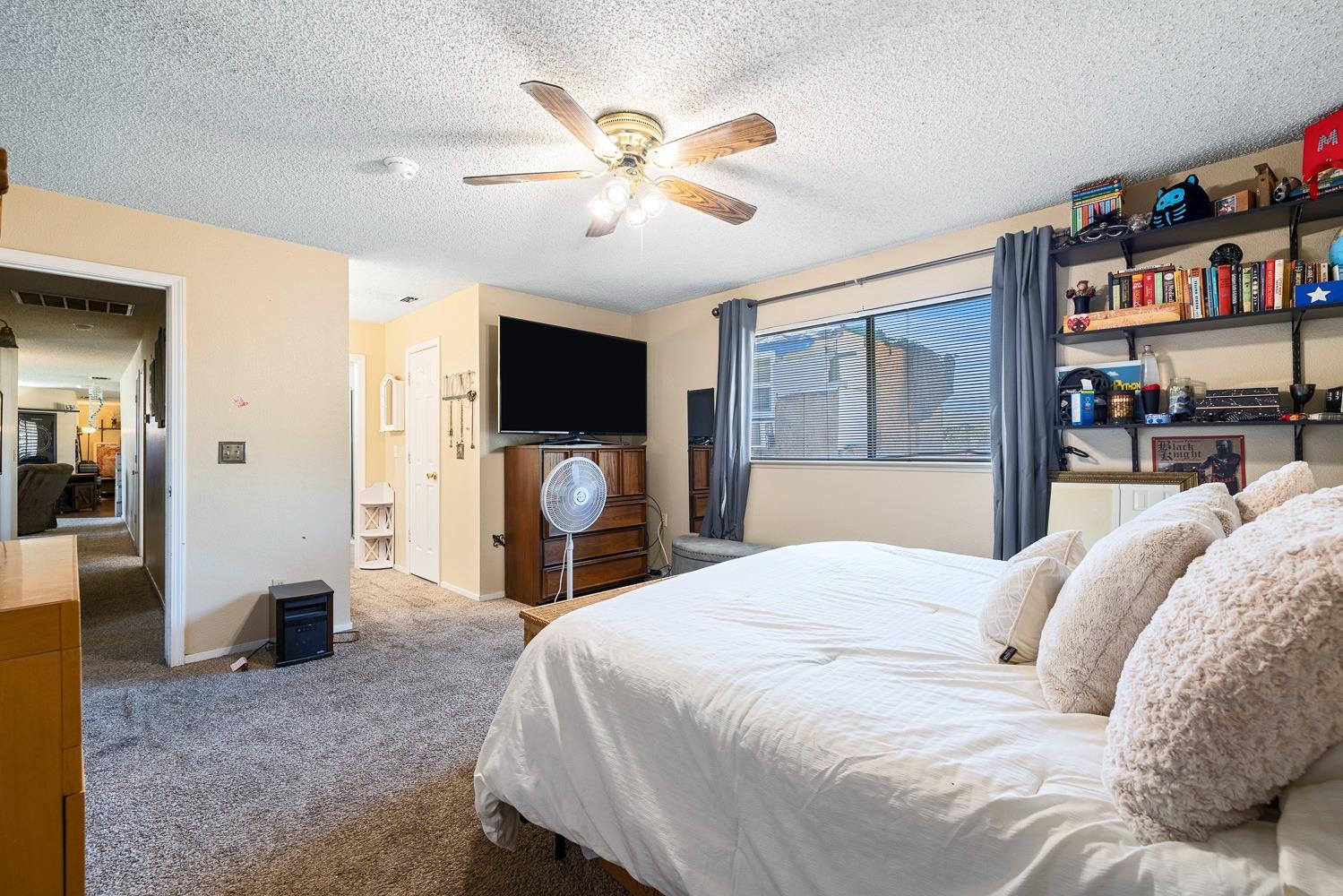 18800 Midland Way Madera, CA 93638 - Photo 16 of 27 a bedroom with a bed and a flat screen tv