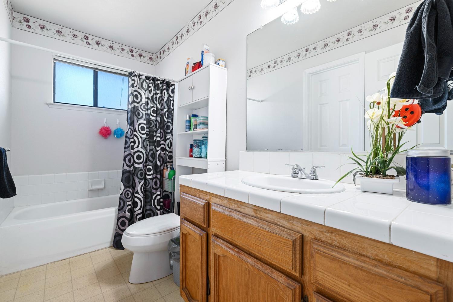 18800 Midland Way Madera, CA 93638 - Photo 20 of 27 a bathroom with a sink a toilet and shower
