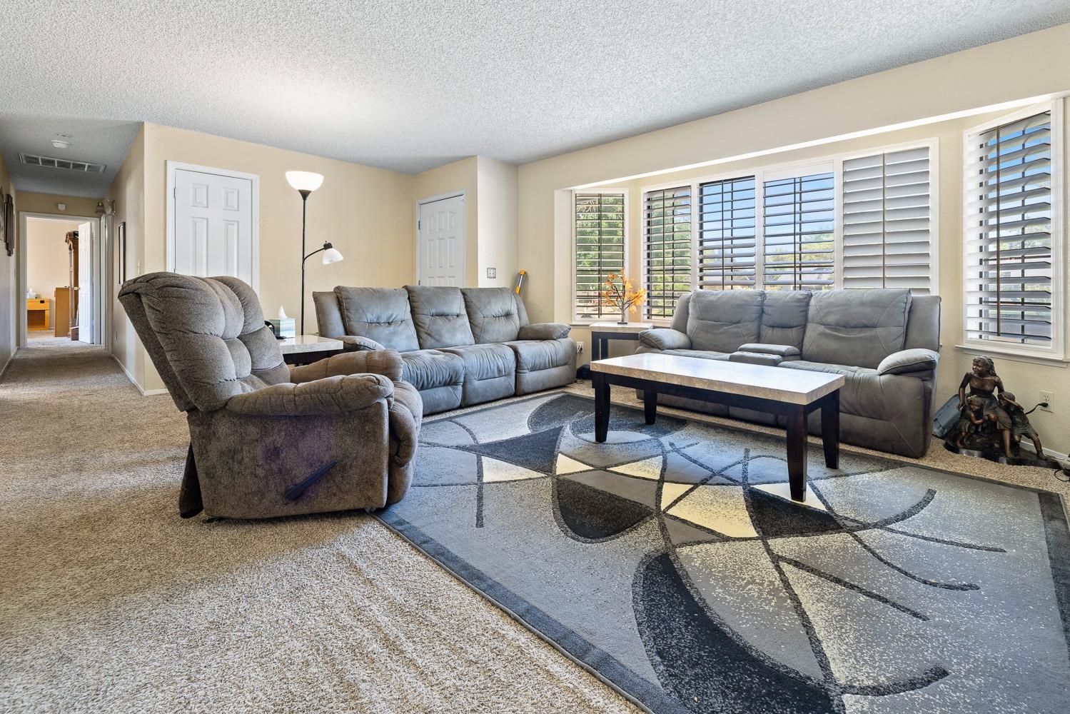 18800 Midland Way Madera, CA 93638 - Photo 4 of 27 a living room with furniture and a floor to ceiling window