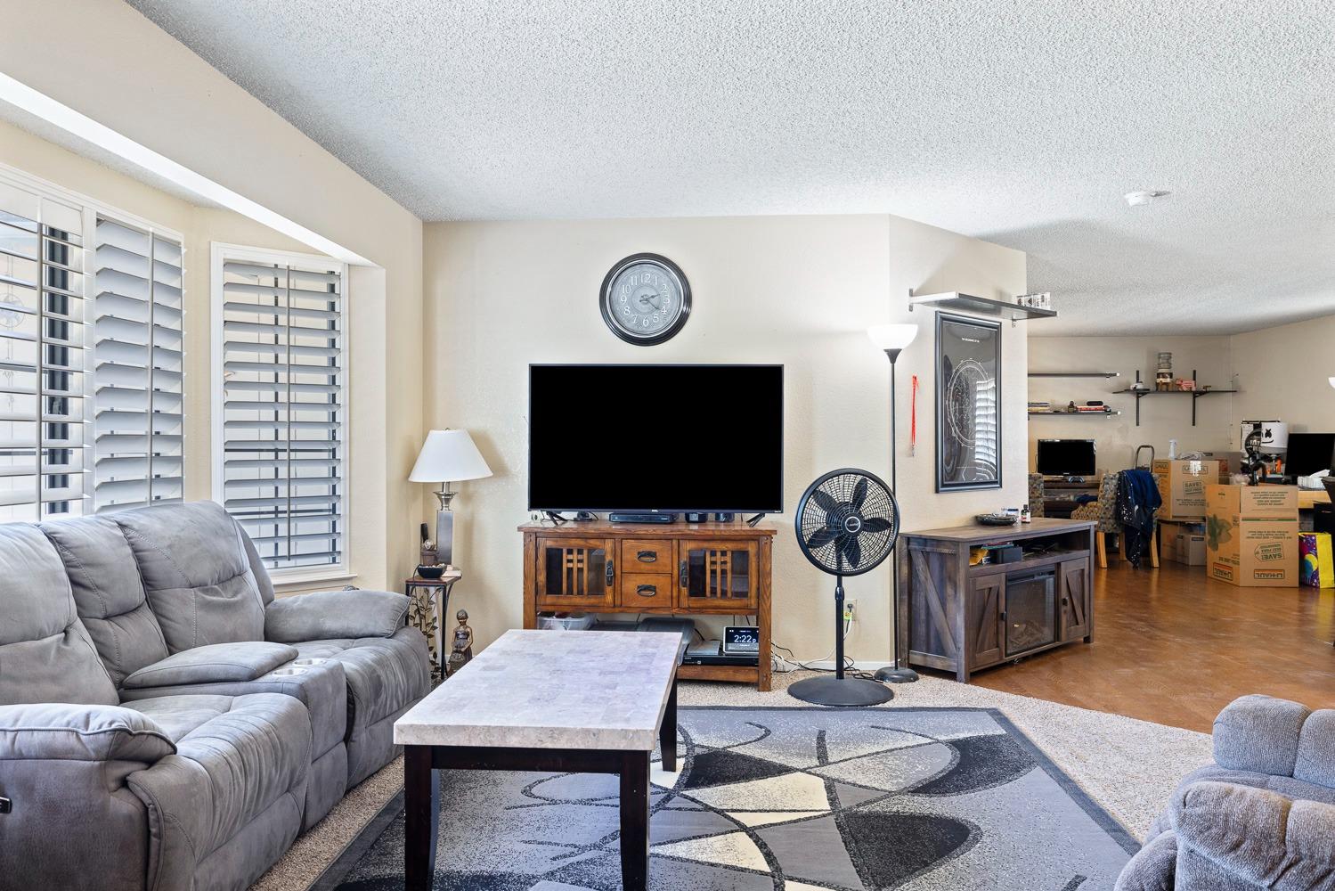 18800 Midland Way Madera, CA 93638 - Photo 5 of 27 a living room with furniture a flat screen tv and a table