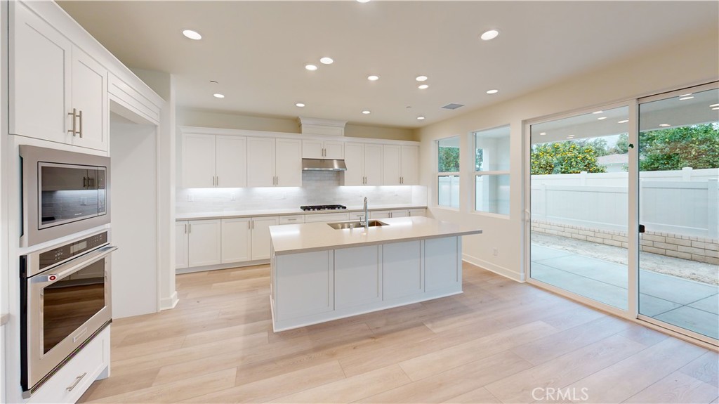 a large white kitchen with a large window
