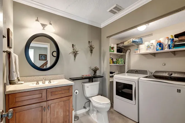 a bathroom with a toilet a sink and a mirror