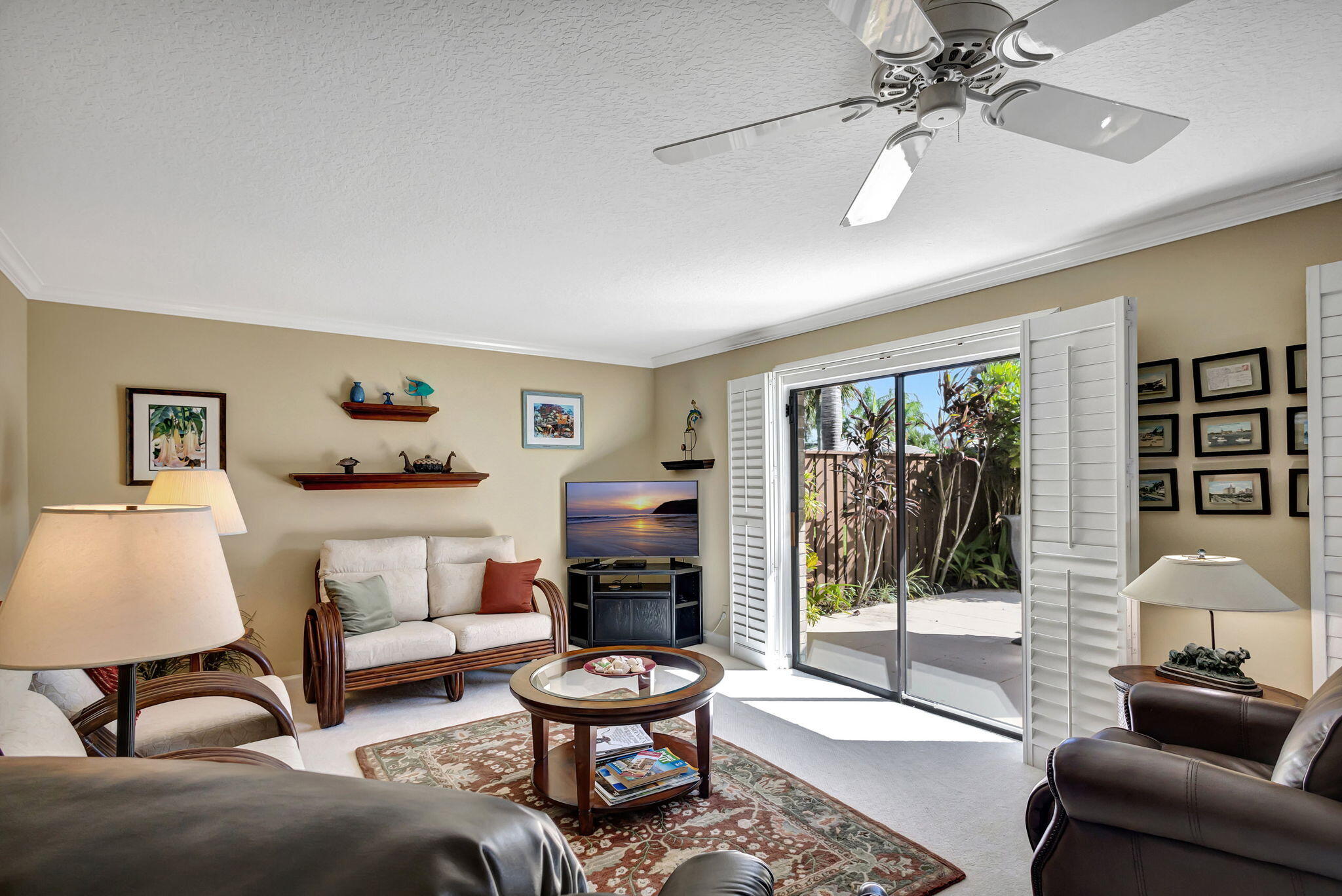 1420 Ocean Way, Unit 23B Jupiter, FL 33477 - Photo 17 of 37 a living room with furniture and a floor to ceiling window