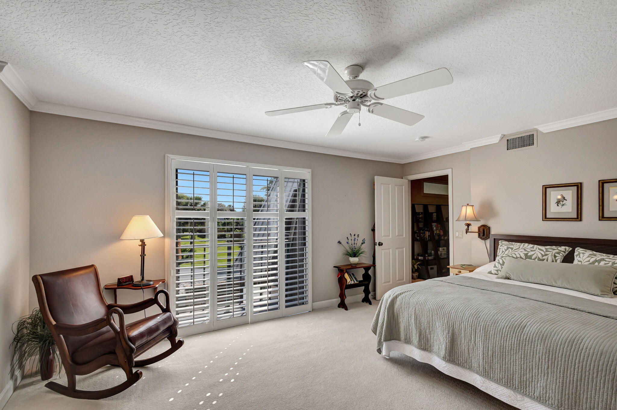 1420 Ocean Way, Unit 23B Jupiter, FL 33477 - Photo 22 of 37 a bedroom with a bed chairs and a window