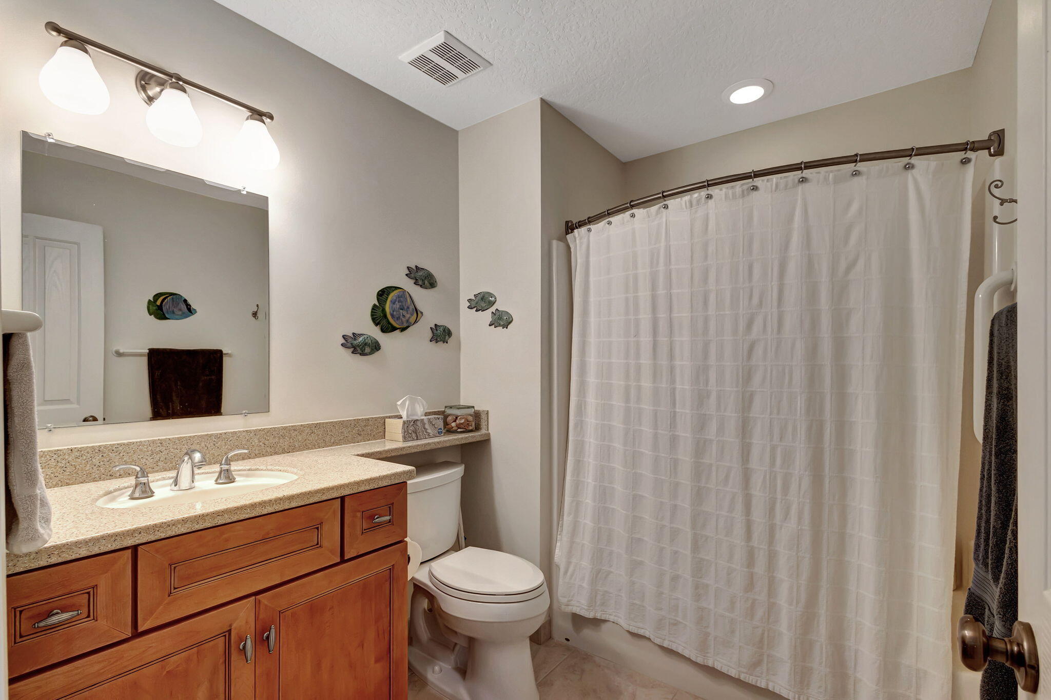 1420 Ocean Way, Unit 23B Jupiter, FL 33477 - Photo 25 of 37 a bathroom with a sink a toilet and a mirror