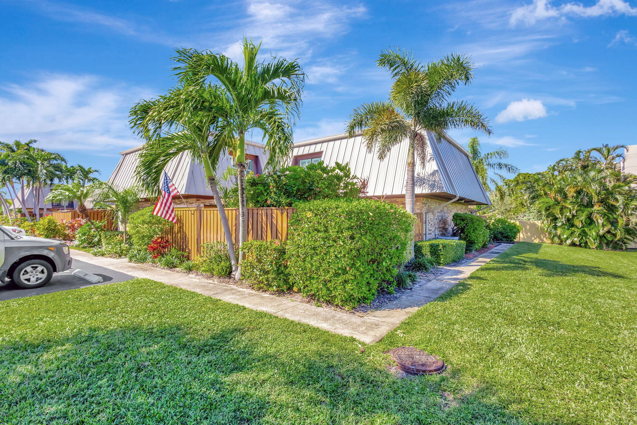 1420 Ocean Way, Unit 23B Jupiter, FL 33477 - Photo 3 of 37 a view of a garden with a tree