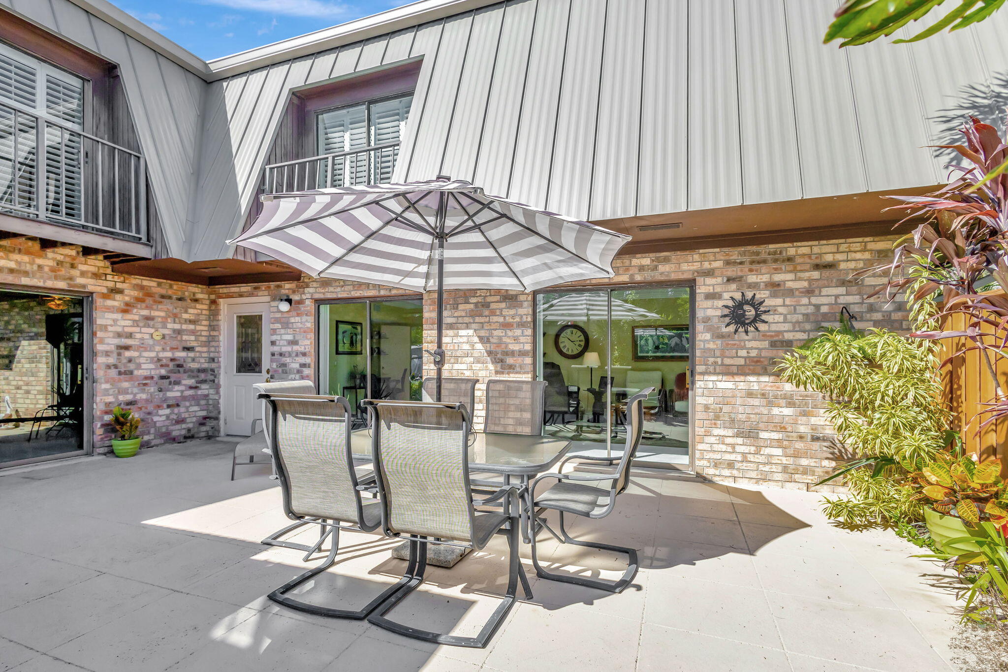 1420 Ocean Way, Unit 23B Jupiter, FL 33477 - Photo 6 of 37 a view of a patio with a table and chairs