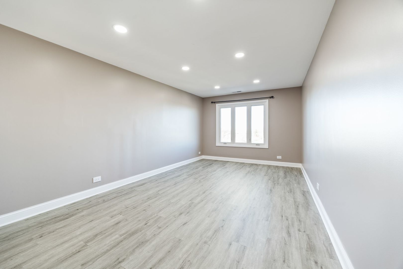 7730 Dempster Street, Unit 406 Morton Grove, IL 60053 - Photo 14 of 32 wooden floor in an empty room with a window