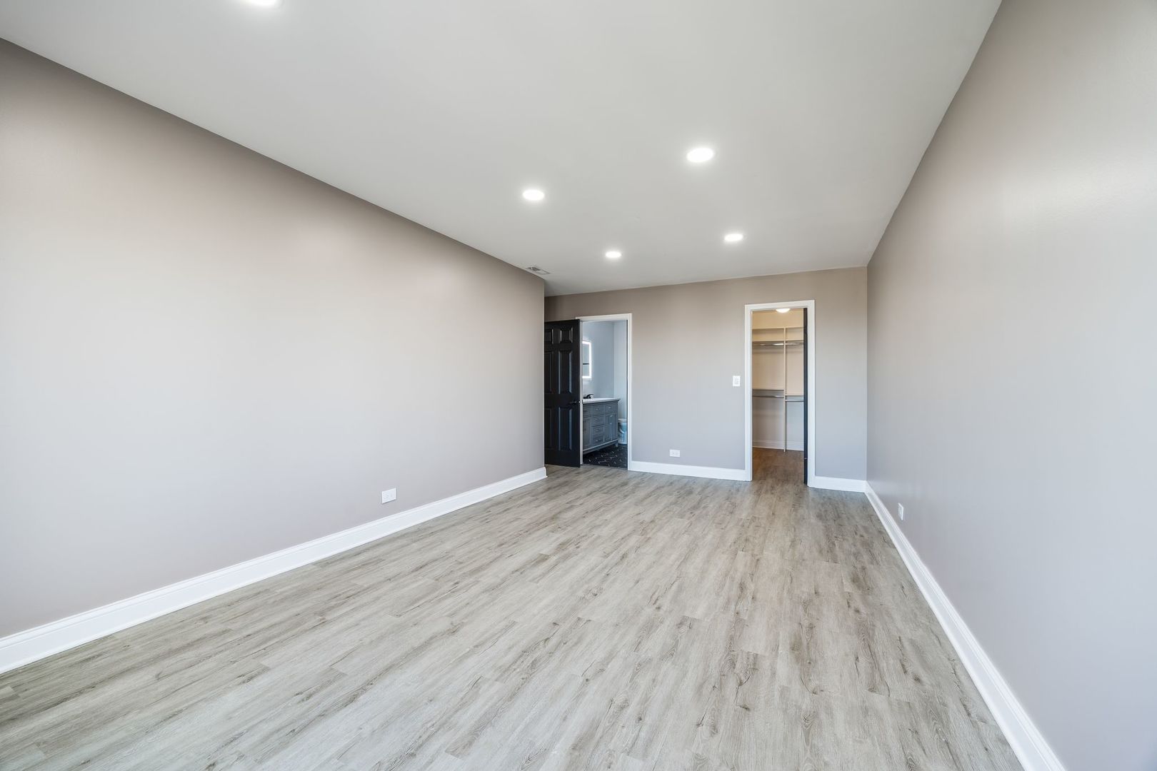 7730 Dempster Street, Unit 406 Morton Grove, IL 60053 - Photo 16 of 32 a view of an empty room with wooden floor