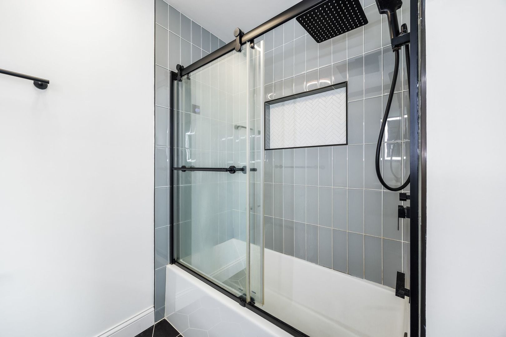 7730 Dempster Street, Unit 406 Morton Grove, IL 60053 - Photo 18 of 32 a bathroom with a glass shower door