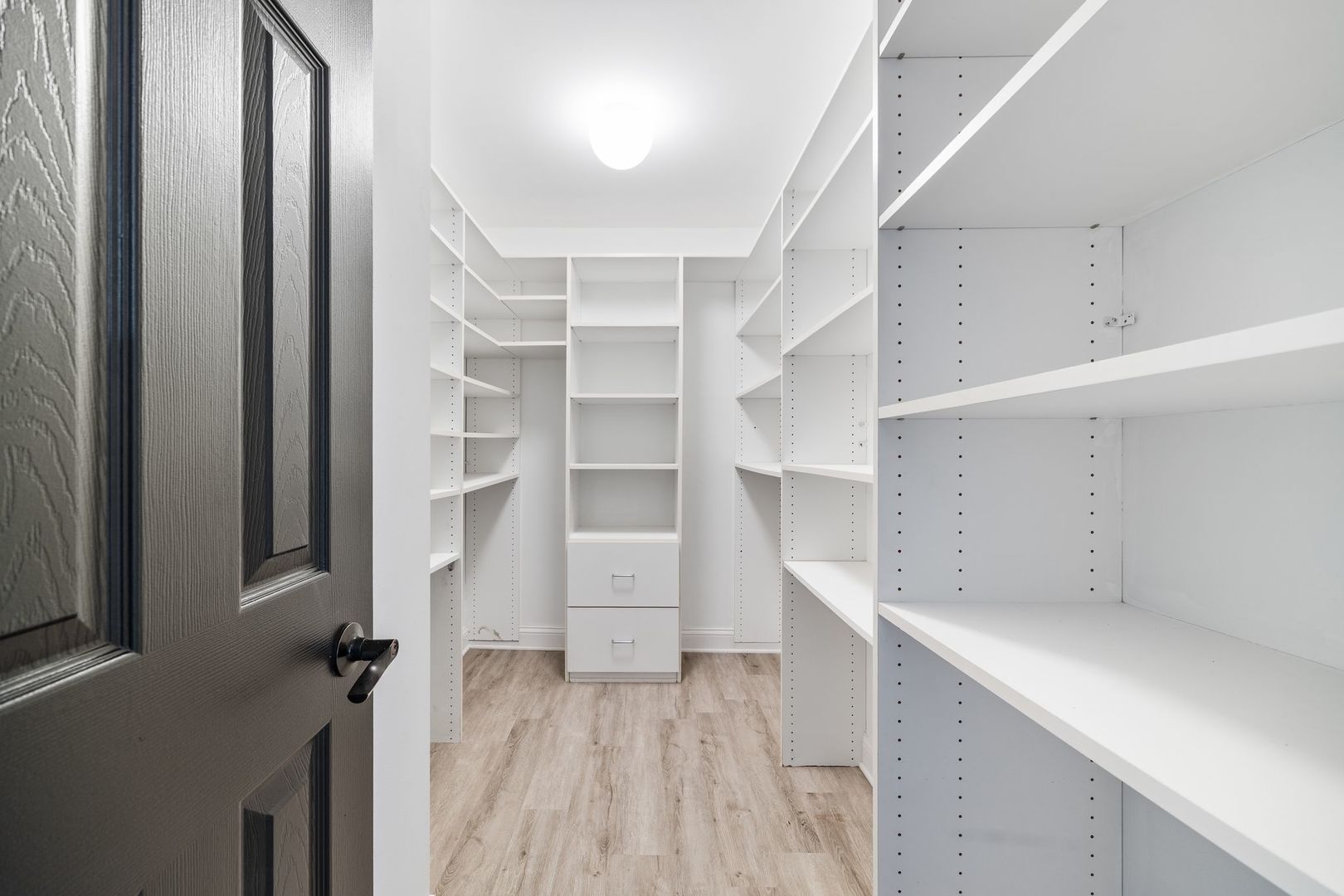 7730 Dempster Street, Unit 406 Morton Grove, IL 60053 - Photo 26 of 32 a view of walk in closet with empty racks