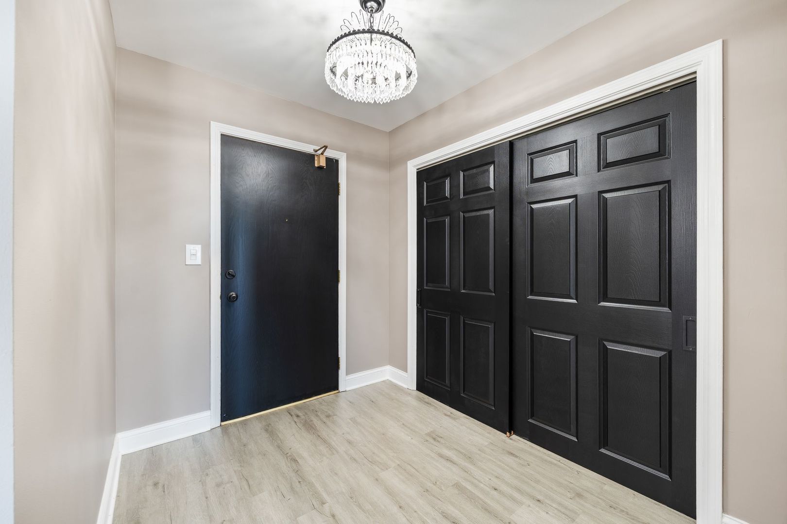 7730 Dempster Street, Unit 406 Morton Grove, IL 60053 - Photo 3 of 32 a view of a hallway with wooden floor