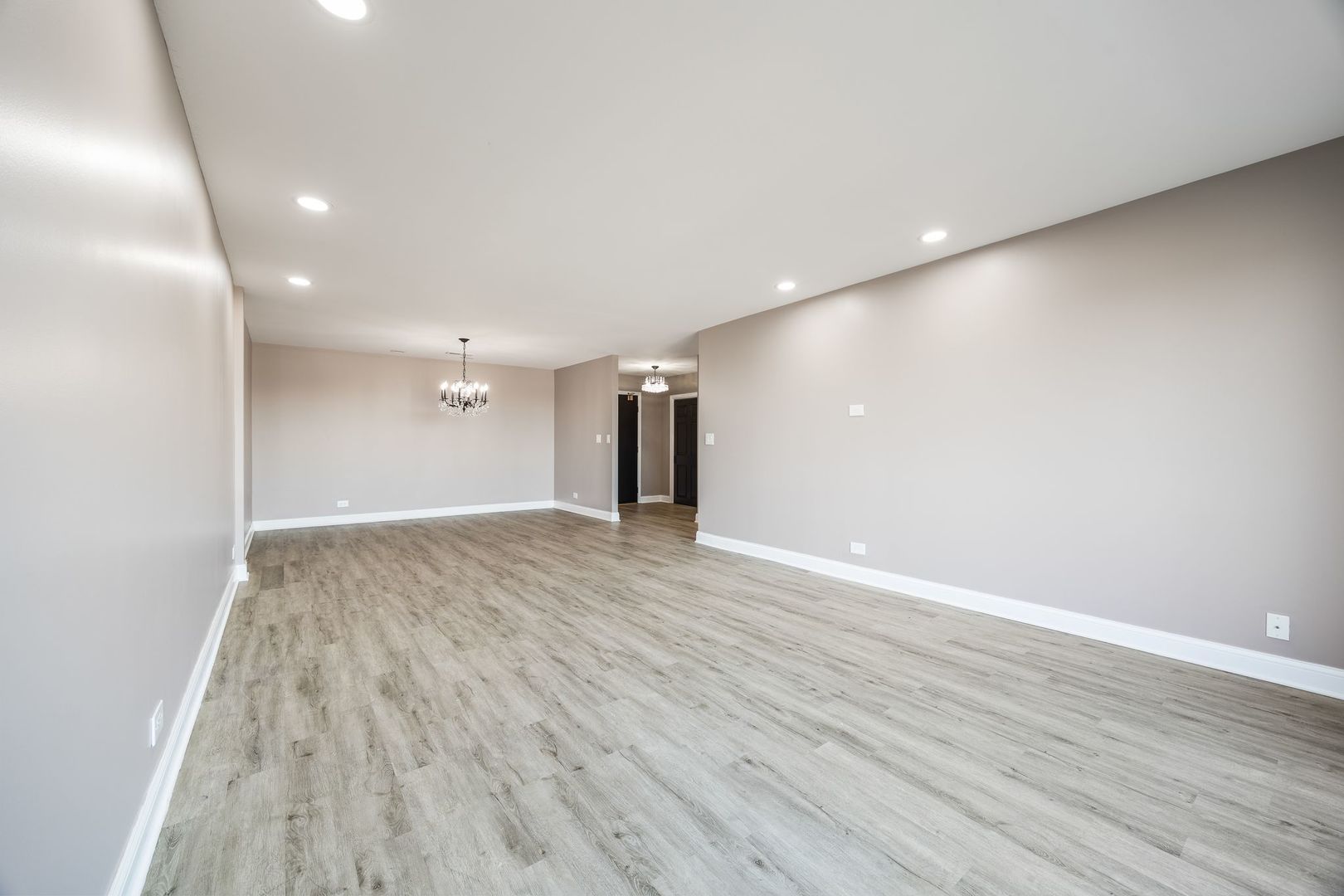 7730 Dempster Street, Unit 406 Morton Grove, IL 60053 - Photo 7 of 32 a view of an empty room with wooden floor