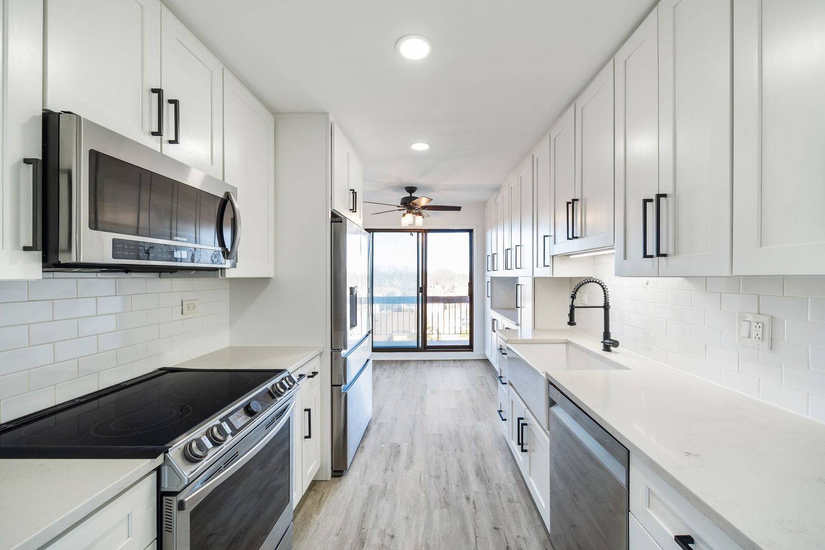 7730 Dempster Street, Unit 406 Morton Grove, IL 60053 - Photo 10 of 32 a kitchen with stainless steel appliances granite countertop a sink stove and microwave