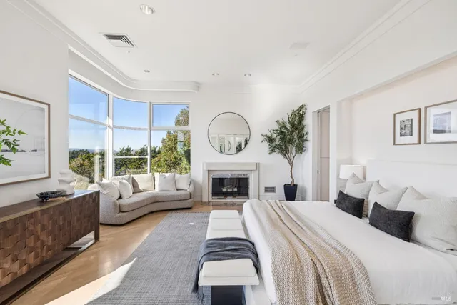 a spacious bedroom with a large bed and a fireplace