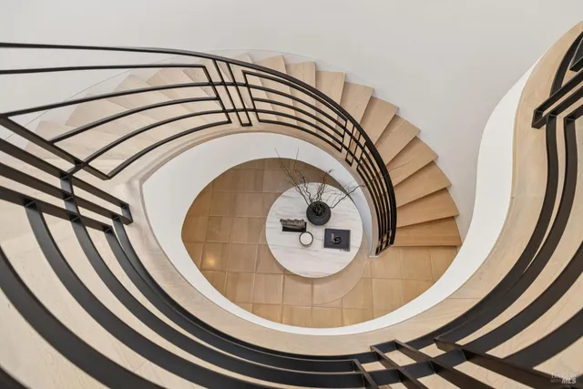 a living room with furniture and floor to ceiling windows