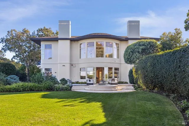 a living room with furniture a large window and a flat screen tv