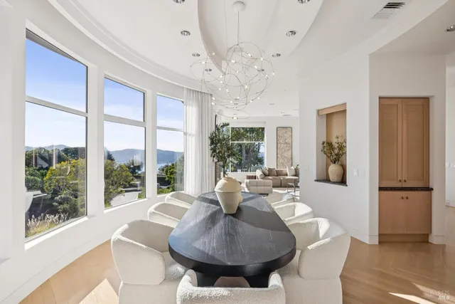 a living room with furniture a chandelier and a large window