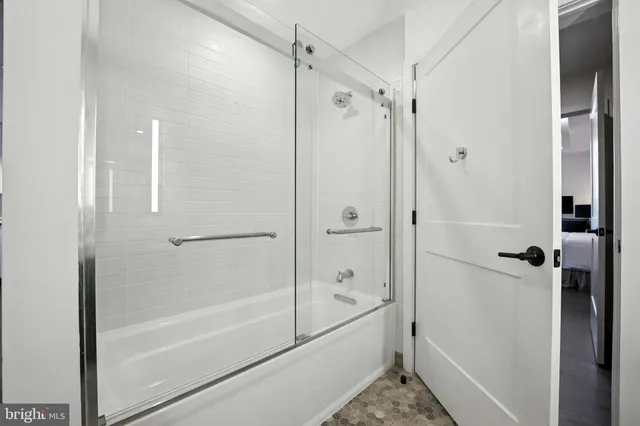 a en suite bathroom with a sink and a washer dryer