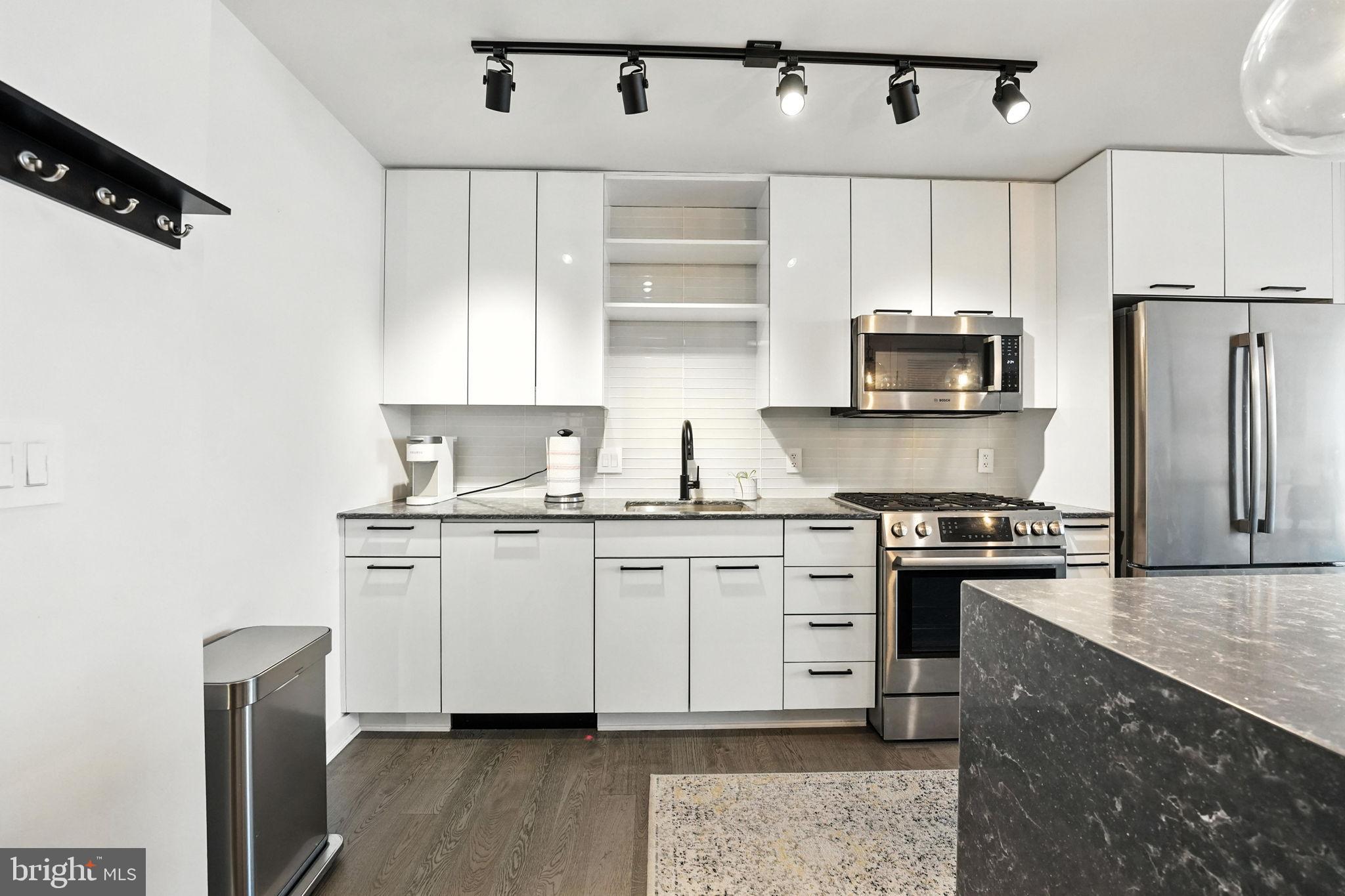 70 N Street Southeast, Unit N913 Washington, DC 20003 - Photo 3 of 60 a kitchen with stainless steel appliances granite countertop a stove a sink and a refrigerator