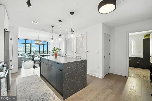 a large kitchen with kitchen island white cabinets and sink