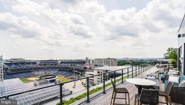 a view of a patio with iron fence