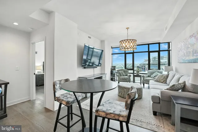a dining room with furniture a chandelier and window