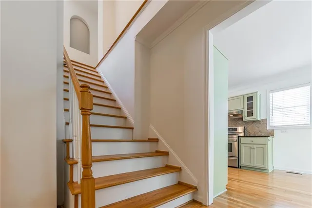 a view of entryway and hall with wooden floor