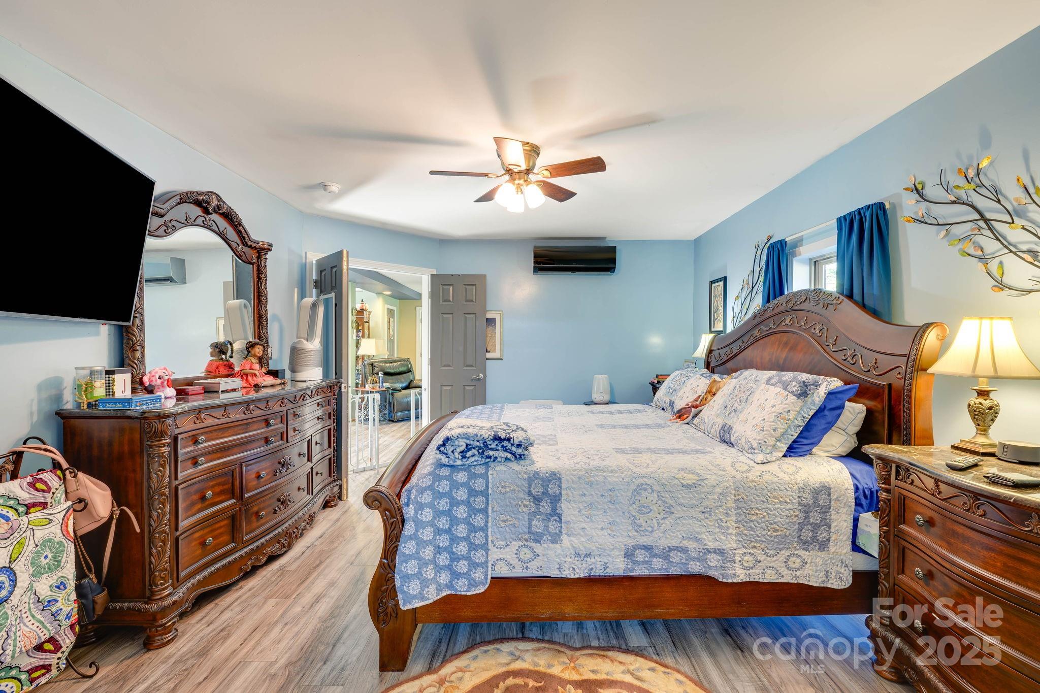1390 Piney Knob Road Rutherfordton, NC 28139 - Photo 12 of 31 a bedroom with a bed and a chandelier