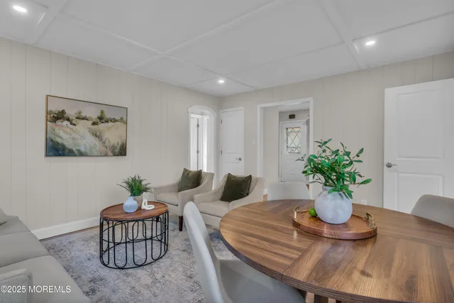 a dining room with furniture and potted plant