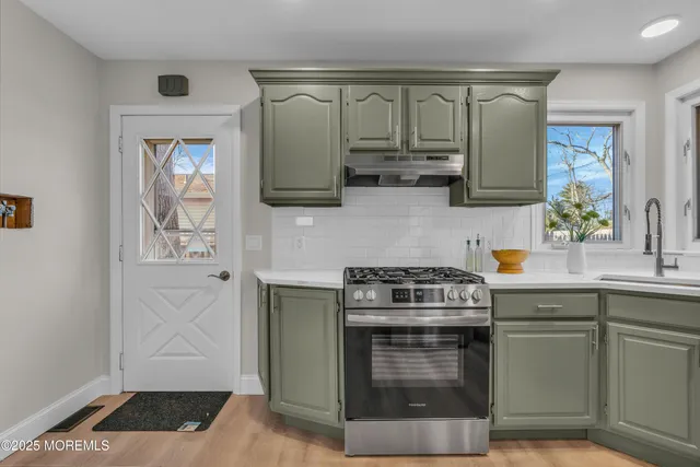 a kitchen with a sink and a stove top oven