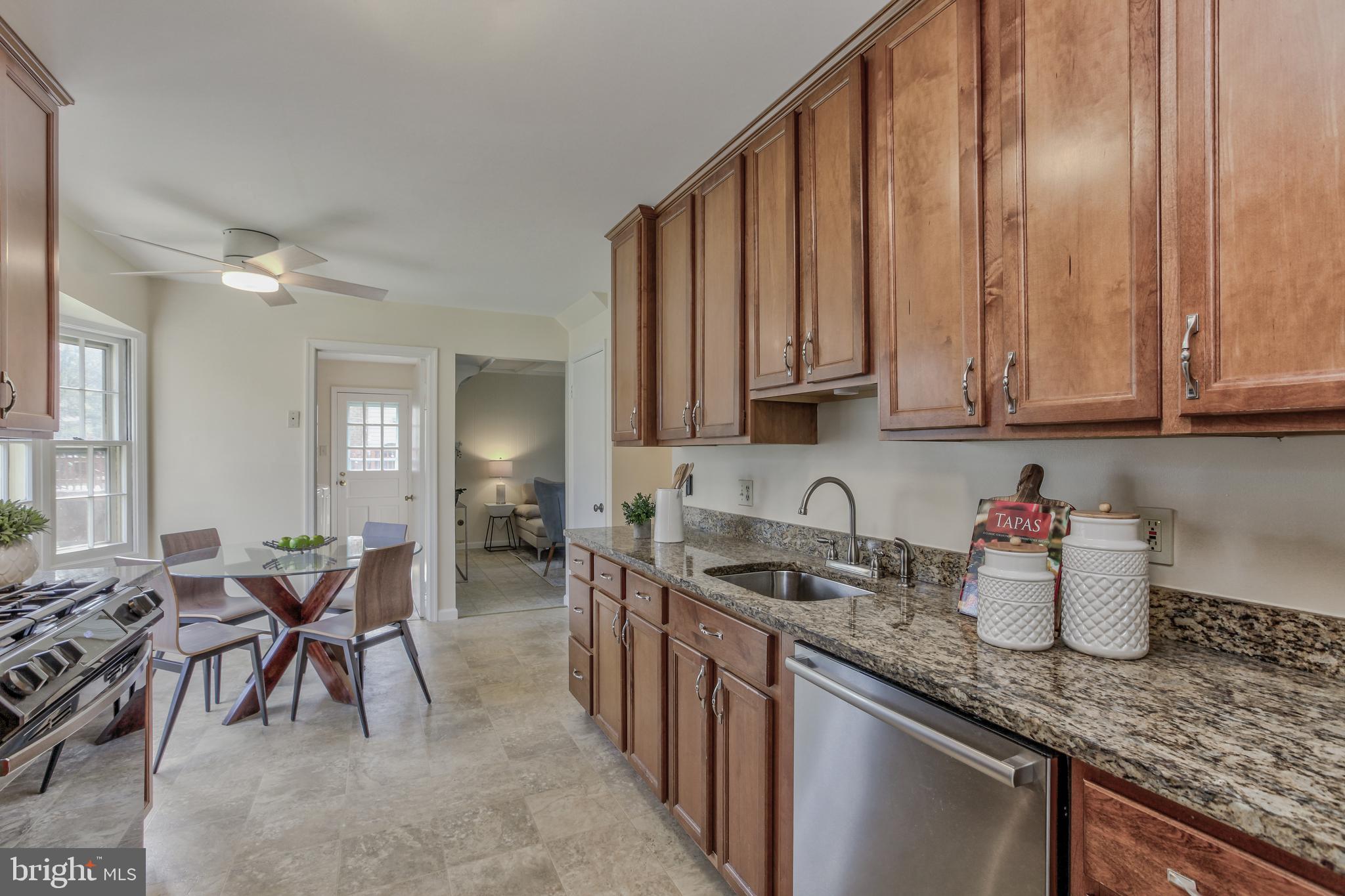 14112 Flint Rock Road Rockville, MD 20853 - Photo 15 of 52 a kitchen with stainless steel appliances granite countertop a sink a stove and cabinets