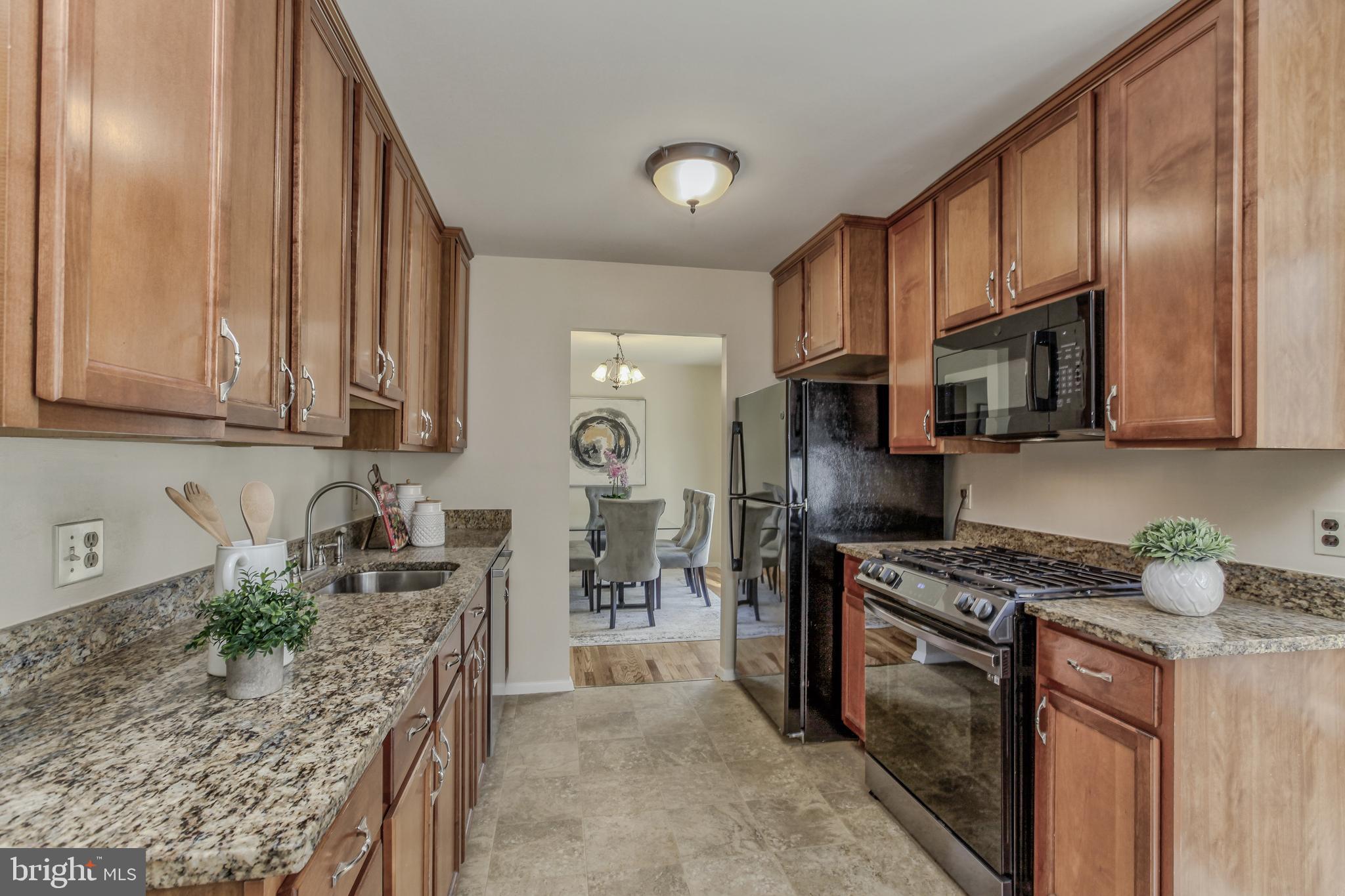 14112 Flint Rock Road Rockville, MD 20853 - Photo 18 of 52 a kitchen with stainless steel appliances granite countertop a stove a sink and a microwave