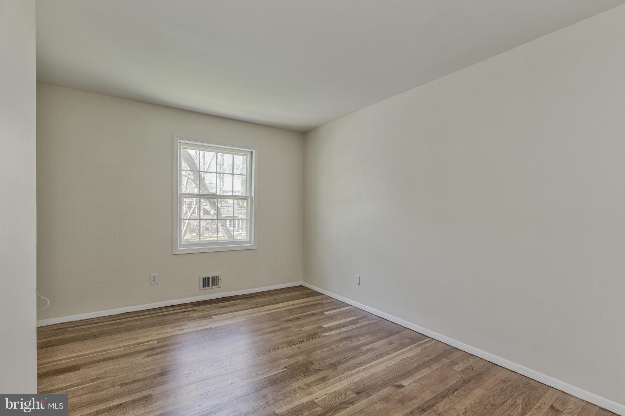 14112 Flint Rock Road Rockville, MD 20853 - Photo 28 of 52 an empty room with wooden floor and window