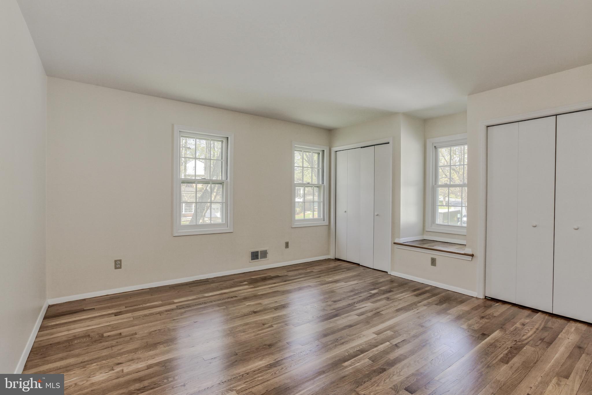 14112 Flint Rock Road Rockville, MD 20853 - Photo 30 of 52 an empty room with wooden floor and windows