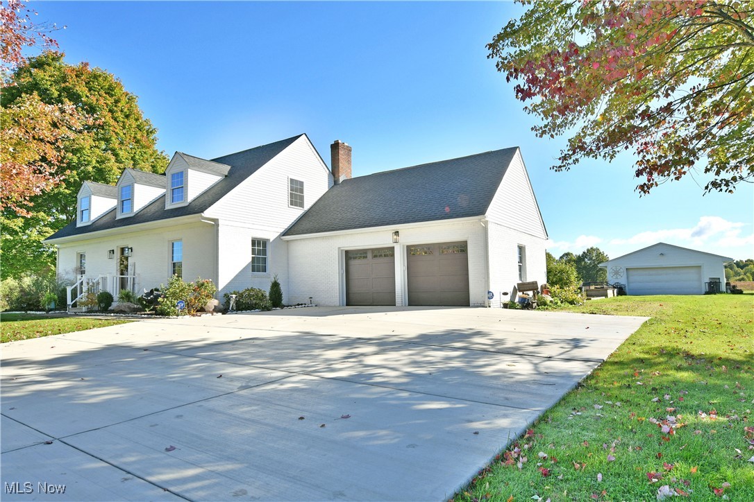 5558 Pierce Road Northwest Warren, OH 44481 - Photo 4 of 50 View of front of property featuring a garage and a front lawn