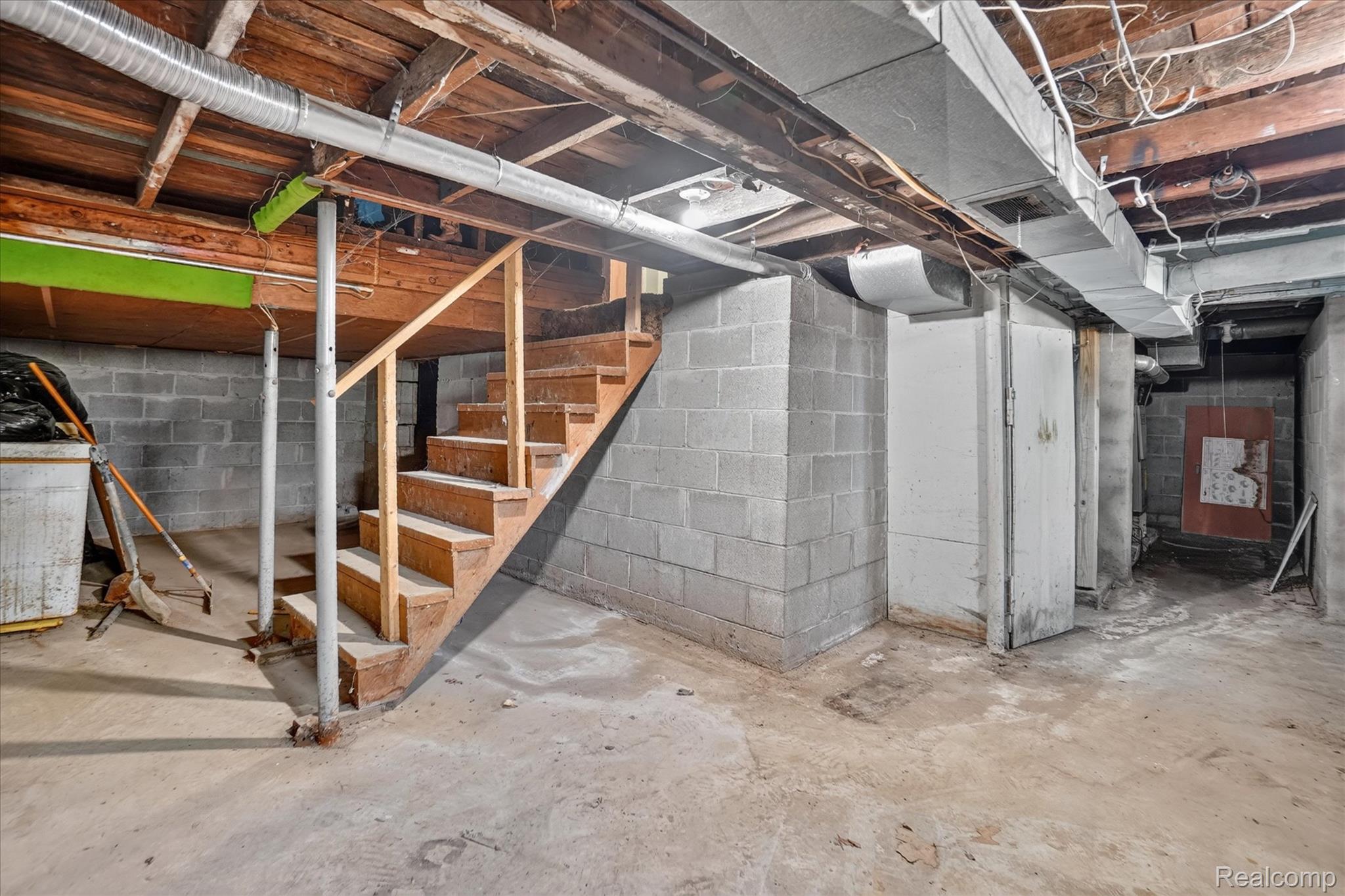 508 Deland Road Flushing, MI 48433 - Photo 26 of 38 Unfinished basement space featuring concrete block walls and exposed wood ceiling joists