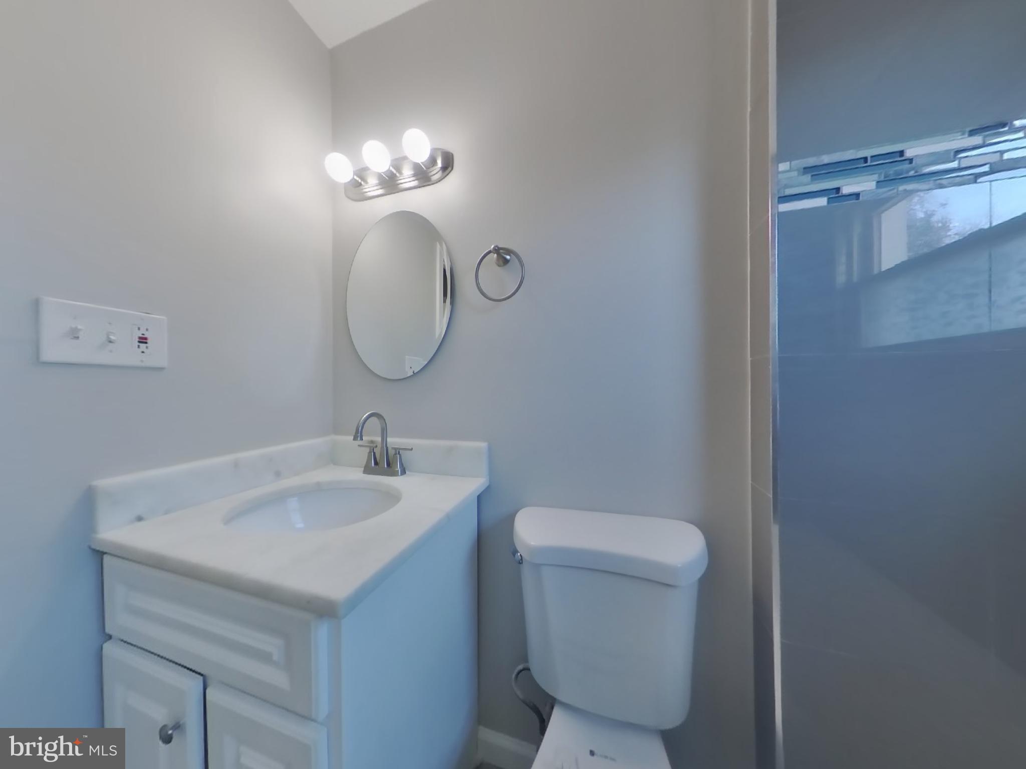4217 Vine Street Capitol Heights, MD 20743 - Photo 11 of 15 a bathroom with a toilet sink and mirror