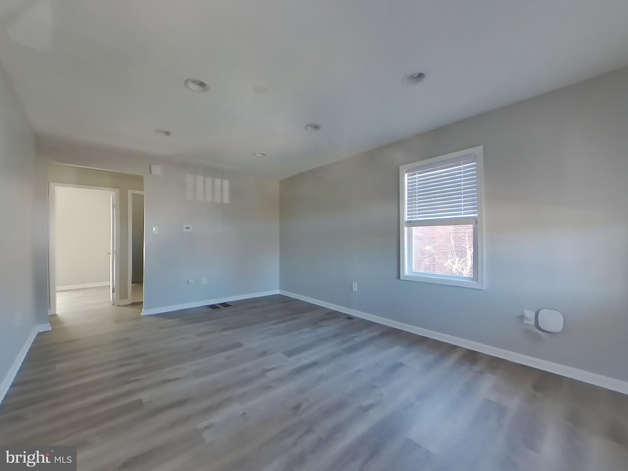 4217 Vine Street Capitol Heights, MD 20743 - Photo 2 of 15 a view of an empty room with wooden floor and a window