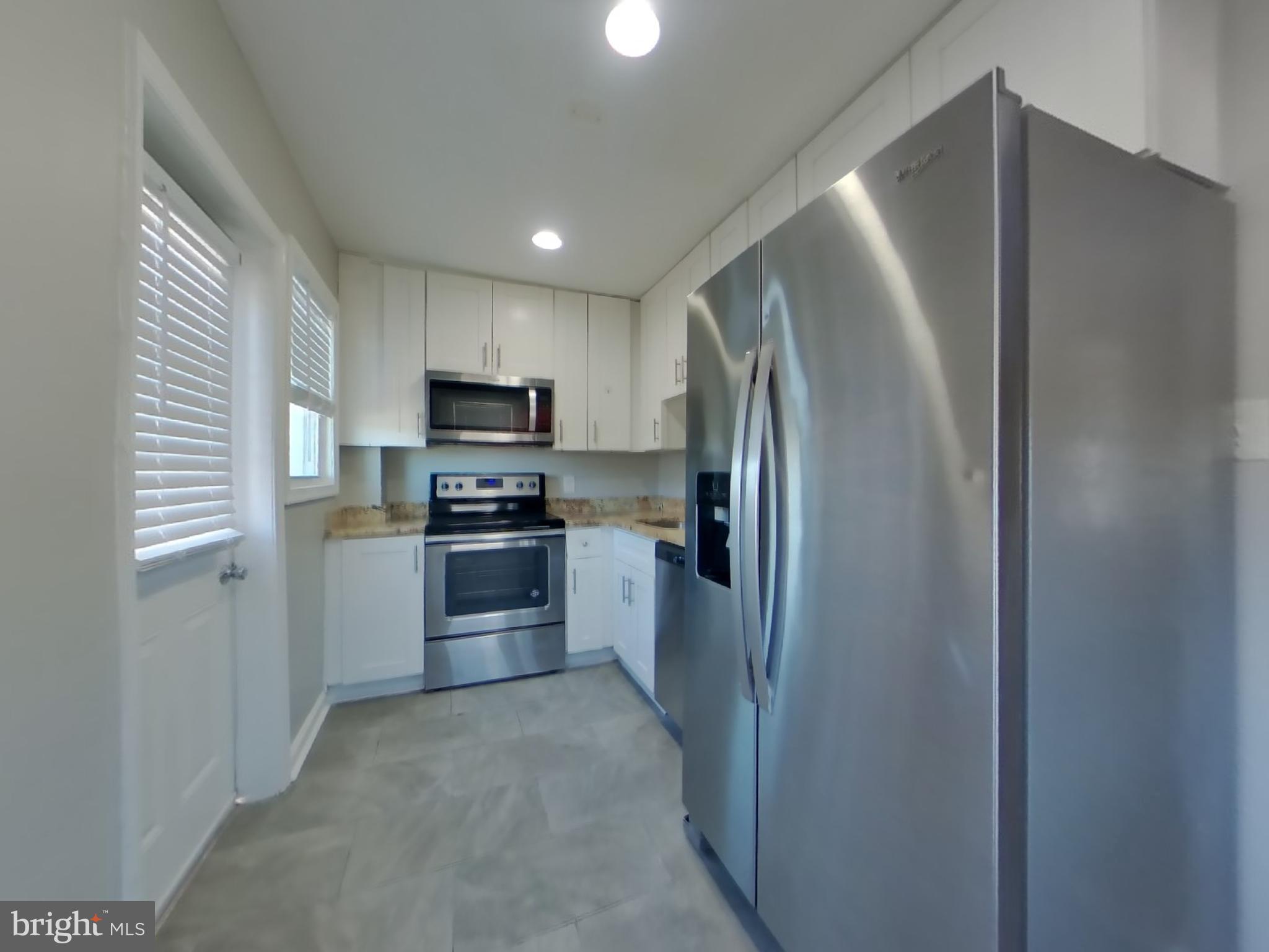 4217 Vine Street Capitol Heights, MD 20743 - Photo 5 of 15 a kitchen with a refrigerator sink and stove top oven