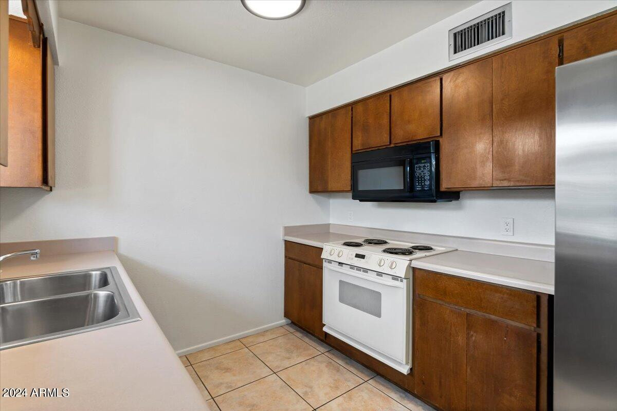 6438 East Butte Street, Unit 2 Mesa, AZ 85205 - Photo 13 of 27 a kitchen with a stove microwave and sink