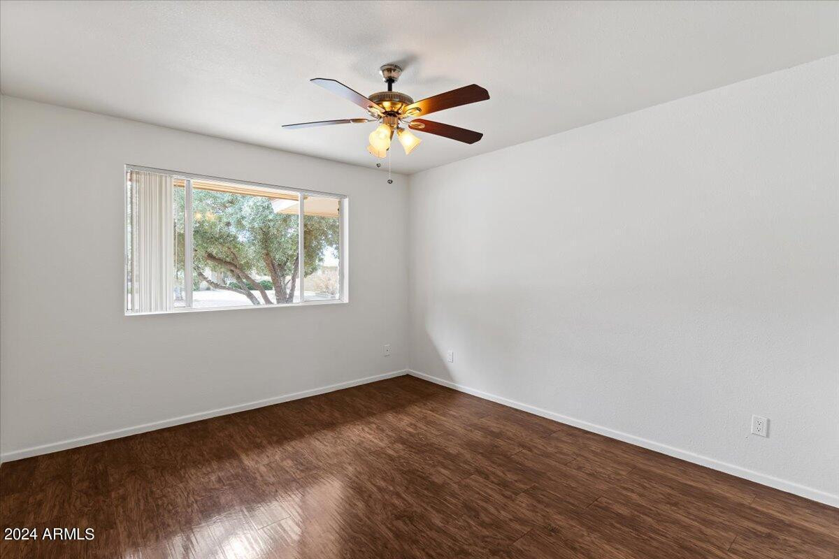 6438 East Butte Street, Unit 2 Mesa, AZ 85205 - Photo 15 of 27 a view of empty room with wooden floor and fan