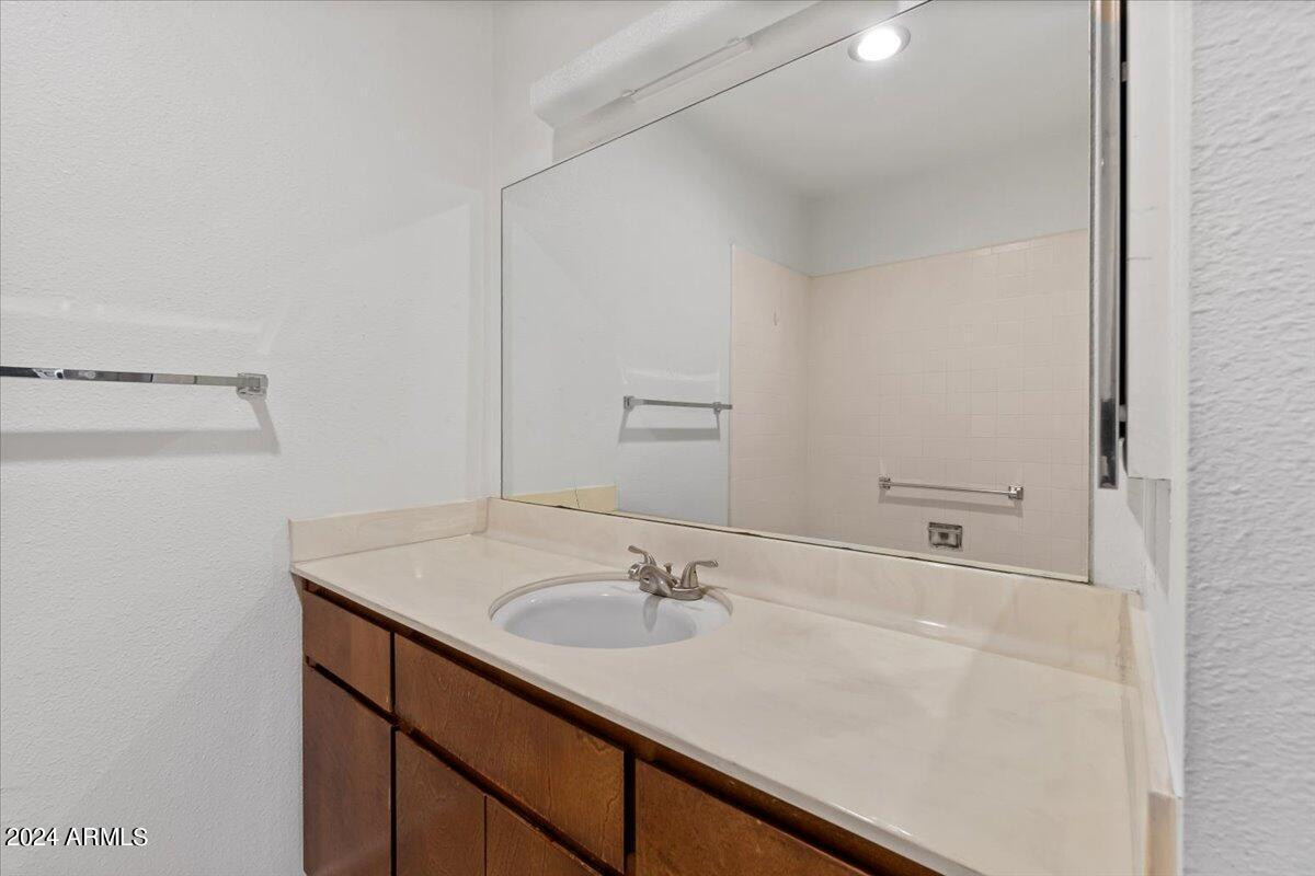 6438 East Butte Street, Unit 2 Mesa, AZ 85205 - Photo 18 of 27 a bathroom with a sink and a mirror