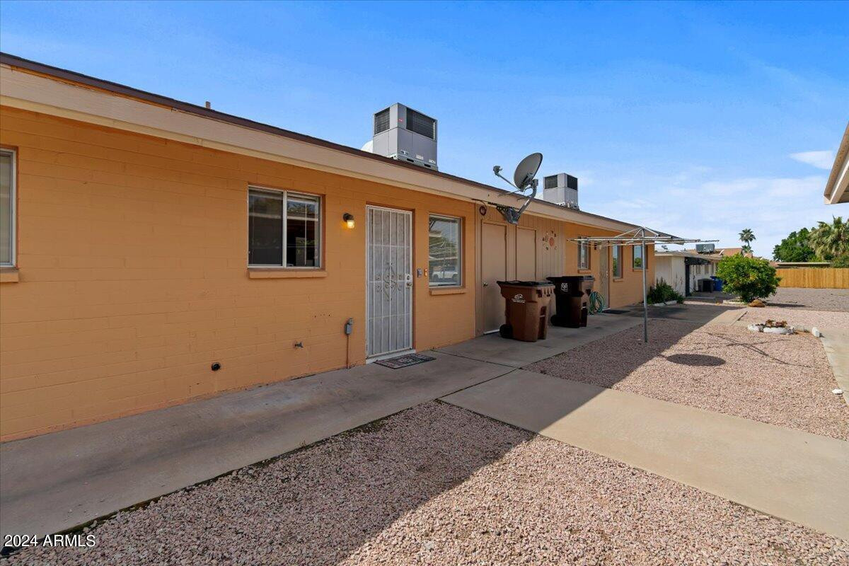 6438 East Butte Street, Unit 2 Mesa, AZ 85205 - Photo 21 of 27 a front view of a house with a yard